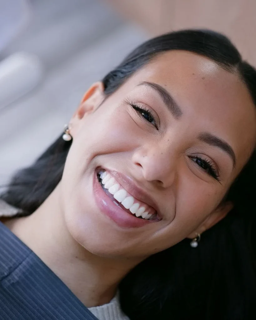 Smile, woman and face, dental and teeth whitening with patient at dentist for treatment and oral care. Health, hygiene and wellness with orthodontics, portrait and happy with veneers for beauty
